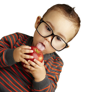 英俊的孩子戴上眼镜吸红苹果 o 的肖像
