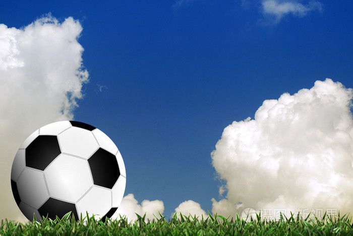 足球运动在绿草与云背景