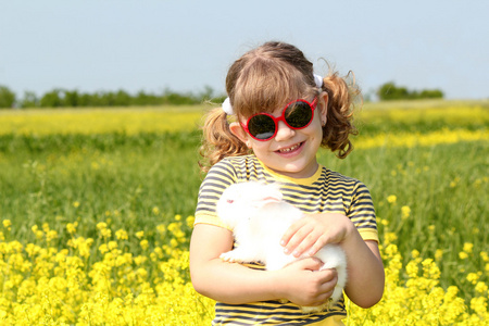 小兔子宠物黄色字段中的小女孩图片