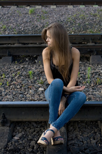 女孩坐在铁轨上