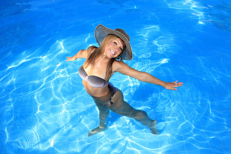 年轻女人享受一个游泳池