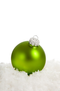 在雪上的绿色圣诞节装饰品。