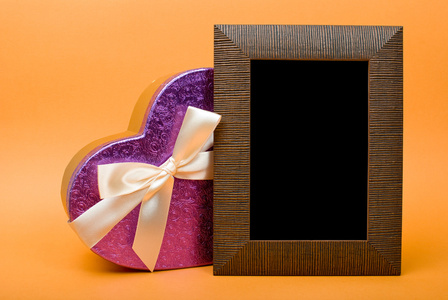 橙色的表现力上丝带木相片框架和心礼品盒