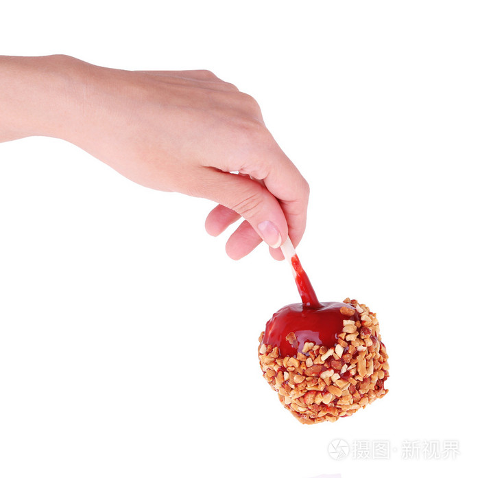 焦糖糖果苹果在手上白色隔离