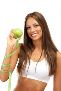 美丽的年轻女子，与绿色的苹果和措施磁带 孤立在白色