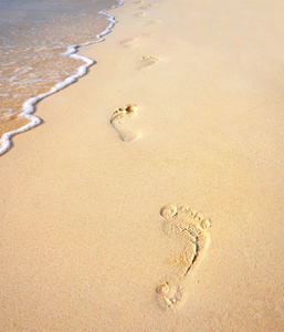 沿着海的沙滩上的脚印