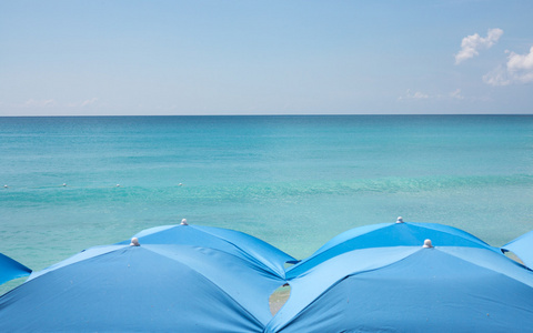 海滩上的四个海滩伞。