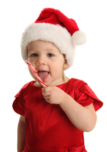 幼儿吃糖果拐杖戴着圣诞老人帽子