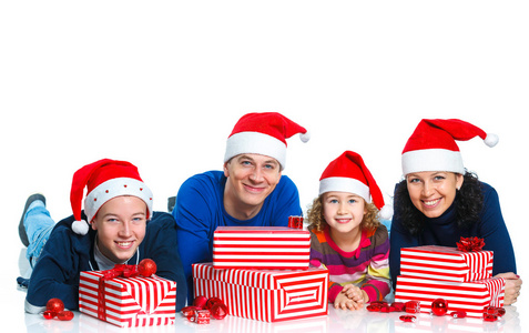 家庭在圣诞老人的帽子与礼品盒