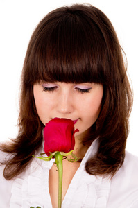 美丽的女孩拥有一朵玫瑰