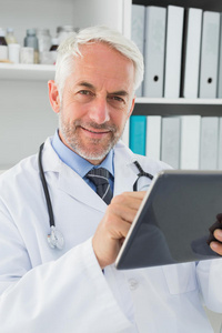 男医生在医务室使用数码平板电脑