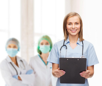 微笑的女医生或护士拿着剪贴板图片