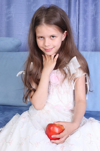 小女孩坐在沙发与苹果公司图片