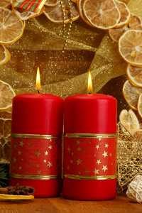 两支蜡烛和圣诞装饰，金色的背景上