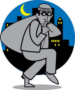 安静的夜贼携带一袋的被盗物品照片