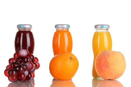 美味的葡萄 桔子和苹果汁玻璃瓶和水果旁边它隔绝在白色中