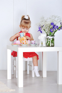 一个小女孩玩娃娃和菜