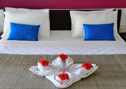 在一家酒店的毛巾和 th 上的花朵装饰房间