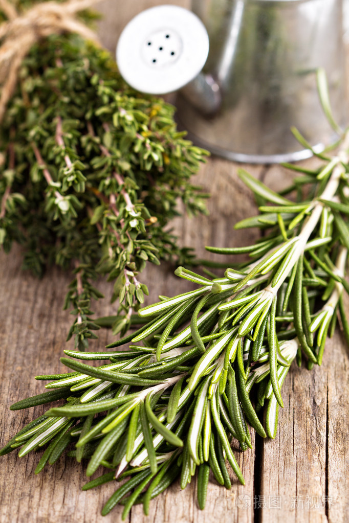 新鲜的迷迭香和百里香木桌子上