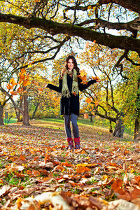 快乐年轻漂亮的女人在秋天的公园