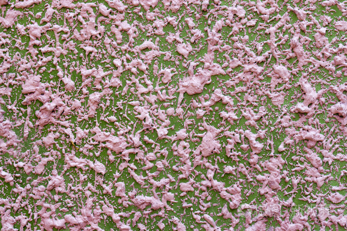 在混凝土墙上的粉红颜色纹理