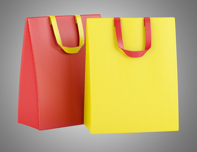 两个空白灰色 backgrou 上孤立的红色和黄色购物袋
