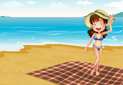 一个女孩在海滩和一条毯子