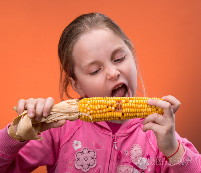 风趣的女孩修整咬干玉米