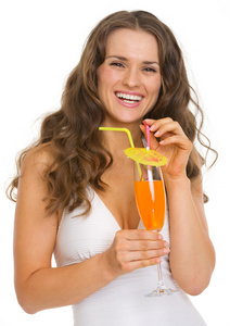 快乐的年轻女人穿泳衣与鸡尾酒的肖像