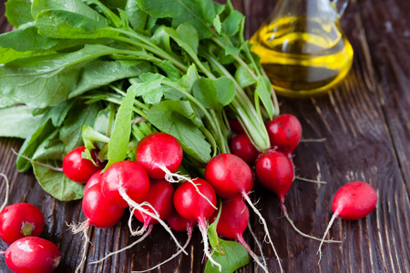 fresh radish with leaves on the boardsand cooking oil