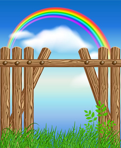 木制围栏对绿草和彩虹
