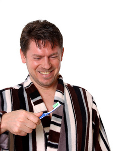 浴袍和牙刷微笑的男人