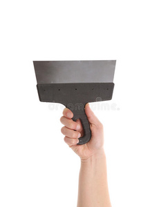 手拿铲手拿着金属抹刀.照片