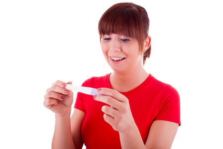 年轻的女人与一个怀孕测试