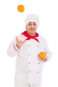 持身穿红色和白色制服的两个橙子的快乐厨师