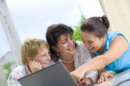 幸福的家庭越来越忙着笔记本电脑的肖像
