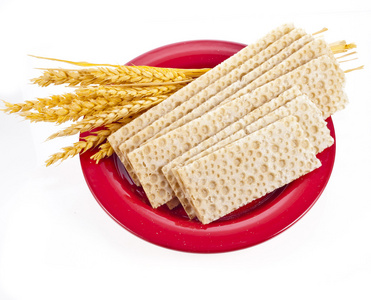谷物面包和耳朵的小麦躺在红板