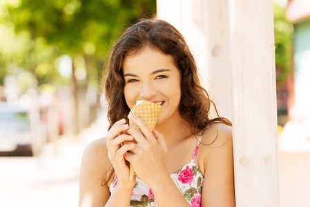 年轻快乐的女人吃冰激淋的肖像