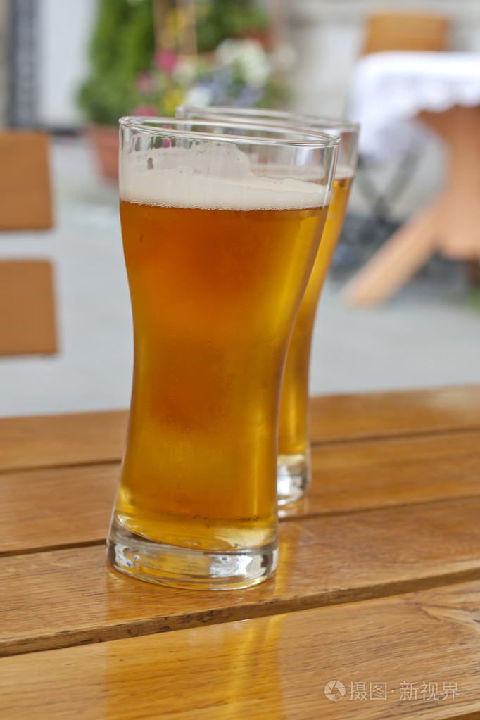 杯中餐厅在户外阳光下桌上的啤酒