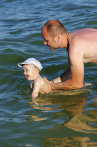 父亲和海水游泳的孩子