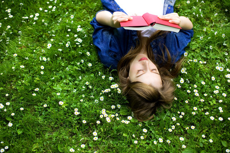 年轻女孩躺在草地上