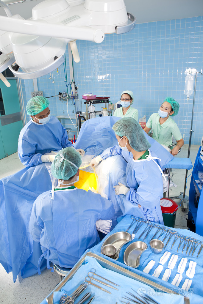 几个外科医生在其工作期间围绕在手术台上的病人