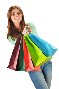 彩色的纸购物袋隔离年轻的幸福女人