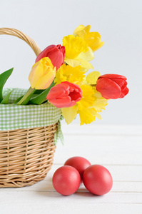 郁金香和水仙在一篮子和彩色的蛋