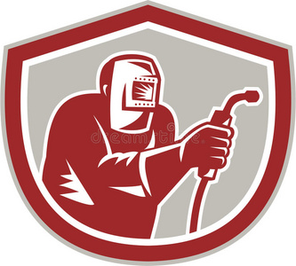 手持焊枪防护罩的焊工照片