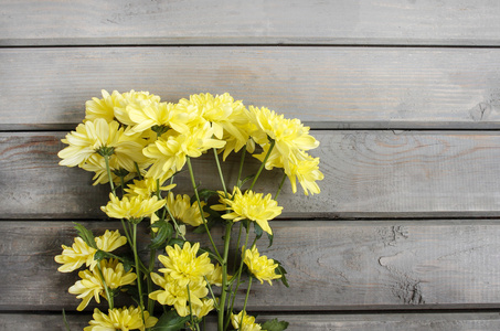 木制背景上的黄色菊花。副本空间