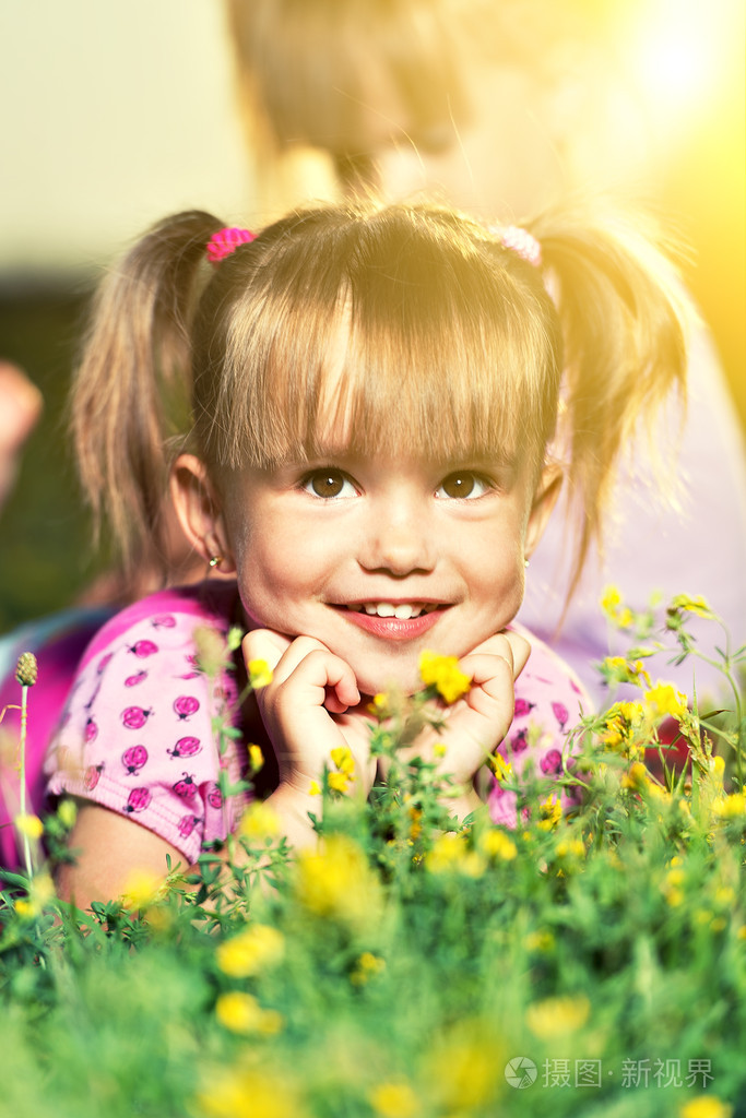 快乐的小宝贝女孩在草地上的肖像