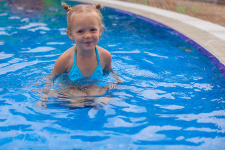 可爱的小女孩享受在游泳池