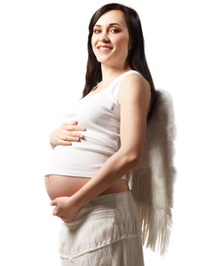 快乐年轻怀孕的白衣女子。在白色隔离