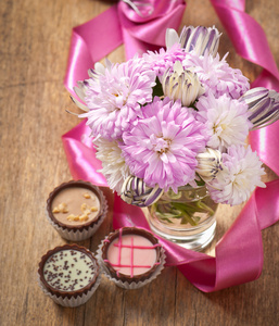 美丽翠菊鲜花花束和巧克力木桌子上